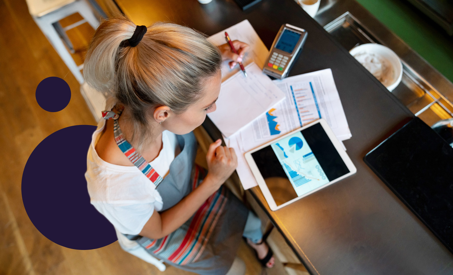 A woman consults a financial report. 