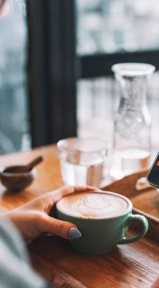 A person buys stocks on their mobile phone.